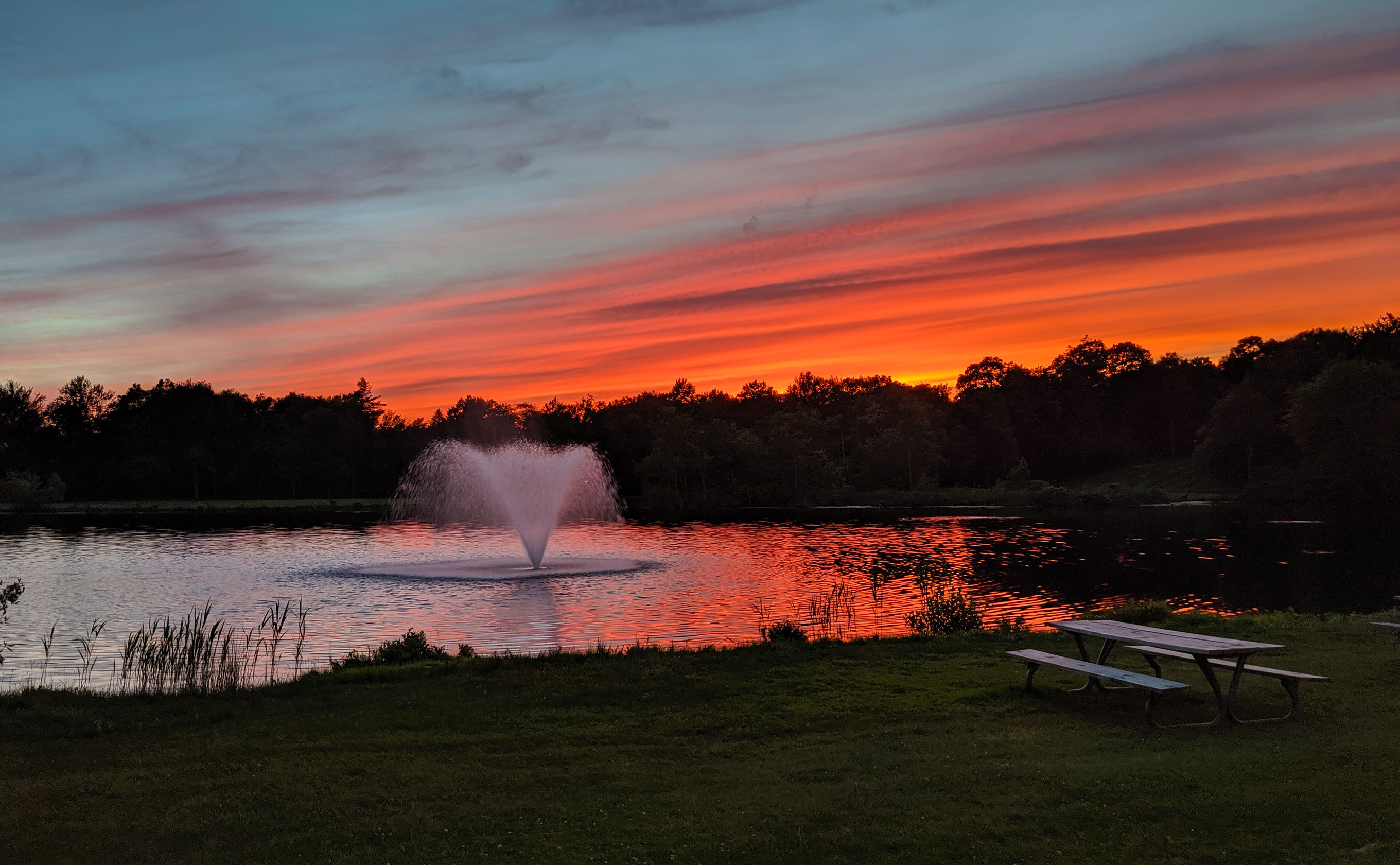 Fountain in the water during a sunset
